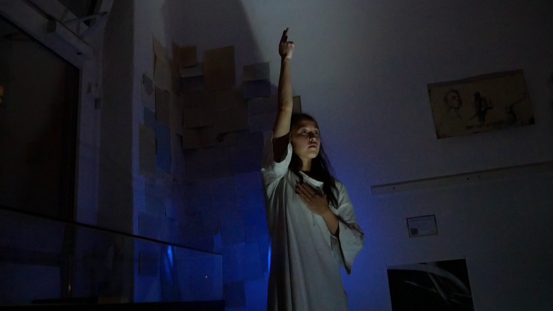 A woman is standing in pose, inspired by the graphical work of Käthe Kolwitz.